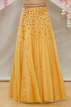 Mustard organza kalidar lehenga with mirror work embroidery. Comes with embroidered blouse and purple scallop hem dupatta.
Component: 3
Pattern: Embroidered
Type Of Work: Mirror work
Neckline: One Shoulder
Sleeve Type: Sleeveless
Fabric: Blouse:Crepe; Lehenga:Organza; Dupatta:Soft Net
Color: Yellow
Other Details: 
Side tassel tie-up lehenga
Occasion: Mehendi and Haldi - Aza Fashions Elegant Festive Georgette Skirt, Anarkali Dress With Flared Skirt For Weddings, Anarkali Wedding Dress With Flared Skirt, Floor-length Flowy Organza Dress, Organza Gown With Pallu For Festivals, Embellished Georgette Skirt For Reception, Floor-length Tissue Silk Dress With Cutdana, Elegant Festive Lehenga With Flowy Skirt, Festive Floor-length Tulle Gown