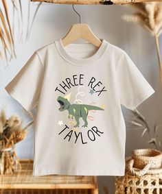 This beautiful customized birthday shirt is for little dinosaur fans. ♥PRODUCTION TIME: 1-5 days (usually 2-3 days) ♥SHIPPING TIME: 2-5 days (usually 3 days) ♥PRODUCT DESCRIPTION: The Bella Canvas 3001T for Toddler is 100% airlume combed and ring-spun cotton (fiber content varies for different colors) Extra light fabric (3.9 oz/yd² (132 g/m Tear-away label * For T-shirt Sizes Please refer to the Listing Image. ♥ CARE INSTRUCTIONS: Machine wash: cold (max 30C or 90F); Don't bleach; Tumble dry: lo 3 Rex Birthday Party Boy, Three Rex Birthday Party Boy, Three Rex Invitation, Boy 3rd Birthday, Toddler Birthday Outfit, Toddler Birthday, Customise T Shirt, Dinosaur Birthday, Boy Birthday Parties