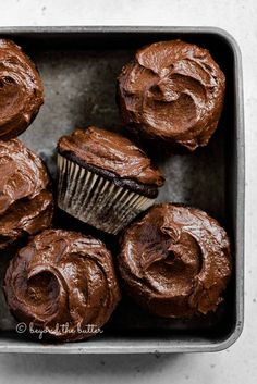 chocolate cupcakes with frosting in a metal pan