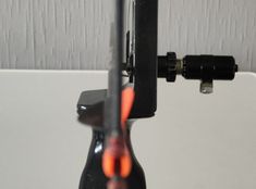 a close up of a bike handle with an object in the background