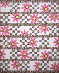 a pink and green quilt with flowers on it