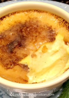 a close up of a bowl of food with ice cream on top and leaves around it