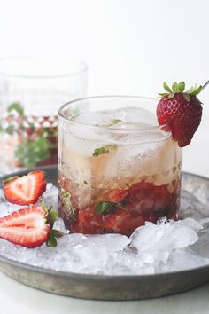 two glasses filled with ice and strawberries