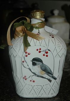 a white vase with a bird painted on it