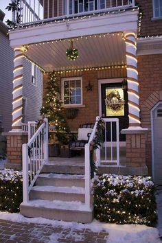 a house with christmas lights on the front porch and steps leading up to the door