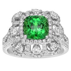 This ring features a fine tsavorite gemstone weighing 2.53 carats. The gemstone is surrounded and accented by 1.30 carats of full-cut diamonds, set in 18K white gold. A ring for someone who understands and appreciates fine colored gems. Ring size 6.5 (sizable) Tsavorite Ring, Diamond Gold Ring, Vintage Cocktail Ring, Expensive Jewelry, Vintage Cocktail, Rare Gemstones, Diamond Gold, Pretty Rings, Gold Diamond Rings