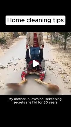 a woman is sitting on the ground with her feet in the air while another person stands behind her