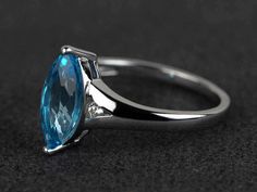 Welcome to my shop, you can find many beautiful gemstone jewelry here, and you also can ask for customized service. Main Stone: Swiss blue topaz, marquise cut, measures 6X12mm;Accent Stones: czMetal: 925 sterling silver plated with rhodium. I also can provide metal options such as 14k solid yellow/white/rose goldSetting: prong setting More rings please go to my shop home: https://www.etsy.com/shop/XCjewelryStudio?ref=hdr_shop_menuIt's a perfect gift for the person who was born in November (Birth Anniversary Marquise Topaz Ring With Accent Stones, Marquise Topaz Promise Ring, Marquise Topaz Ring With Prong Setting For Promise, Marquise Topaz Ring For Promise Occasion, Marquise Cut Topaz Ring With Accent Stones For Anniversary, Wedding Topaz Three Stone Ring, Elegant Marquise Cut Blue Topaz Ring, Wedding Blue Topaz Three Stone Ring, Marquise Blue Topaz Ring For Promise