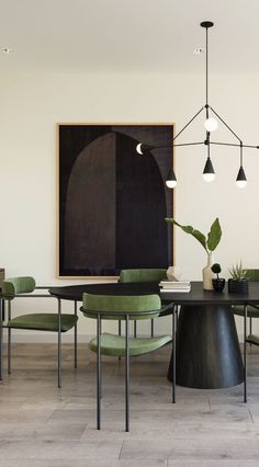 a dining room table with green chairs and a black painting on the wall behind it