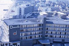 an aerial view of a large building with windows and balconies on the roof