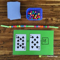 the cards are next to a pencil and some beads