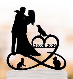 a wedding cake topper with a silhouette of a couple and their dog on it