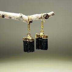 "Black Tourmaline Earring - Gold Plated You will receive 1 (ONE) pair of Gold Plated Black Tourmaline Earrings like the pictured. \"Stone of Protection\" BLACK TOURMALINE is a very powerful spiritual grounding stone that protects against negativity of all kinds. It sucks up any negativity it encounters. However, it does not absorb negative energy. It actually transmutes negative energy into positive energy. FOLLOW US ON INSTAGRAM @earthsmineralsinc Thank you ! Pictures and colors Please note tha Black Tourmaline Jewelry, Black Tourmaline Stone, Black Tourmaline Crystal, Tourmaline Earrings, Crystal Dangle Earrings, Tourmaline Jewelry, Tourmaline Stone, Tourmaline Crystal, Tourmaline Gemstone