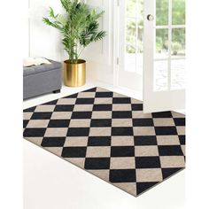 a black and white checkered area rug in front of a door with potted plant