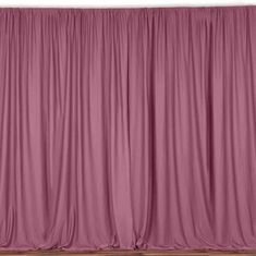 an empty stage with pink curtains and wooden floors