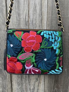 These unique embroidered leather crossbody bags are super fun to wear! Has one big compartment and smaller zipper one inside. Comes with chain and leather braided strap for unique look. Perfect side for everyday wear. Measurements: Length: 10in Height: 8in Width: 3.5in Strap has a 21 in drop measuring 42 inches long all together Mexican Purse, Hand Made Bag, Mexican Bag, Artisan Bag, Chain Strap Bag, Embroidered Leather, Floral Bags, Strap Bag, Brown Leather Bag