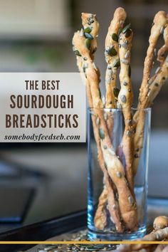 the best sourdough breadsticks in a glass on a tray with text overlay