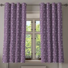 a window with purple curtains in front of it and a radiator on the side