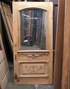 an old wooden door with a mirror in it