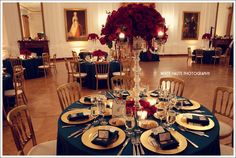 a table is set with place settings and flowers in vases on the centerpiece