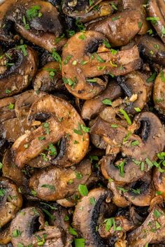 cooked mushrooms with parsley on top in a white bowl, ready to be eaten