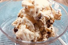 a glass bowl filled with ice cream on top of a wooden table