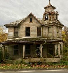 an old run down house with a steeple on the roof and a clock tower