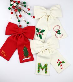 three christmas stockings with bows on them and the letters m, m, n are decorated with candy canes