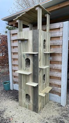 a wooden bird house built into the side of a building