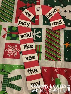 a quilt made to look like christmas stockings and snowmen with words that spell out the word