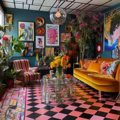 a living room filled with lots of colorful furniture and pictures on the wall above it