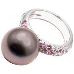 18k White Gold Diamond And Pink Sapphire With Large Tahitian Pearl Ring by Cartier. With1 Tahitian pearl 12.5mm 12 round brilliant cut diamonds VS1 clarity, E color total weight approx. .36ct 15 round pink sapphires. This ring comes with original Cartier box. Details: Ring Size: 4.5 US, Europe 48 Weight: 9.1 grams Width: 12.5mm Stamped Hallmarks: Cartier 750 48 Cartier 2001 N94708 *Free Shipping within the United States* YOUR PRICE: $4500 T1445tedd Sapphire White Gold Ring, Tahitian Pearl Ring, White Gold Sapphire Ring, Sterling Silver Cz Rings, Vintage Designer Jewelry, Pink Sapphire Ring, Tahitian Pearls, Pearl Diamond, White Gold Ring