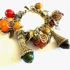 Vintage Bakelite Charm Bracelet. The Silver Tone Charm Bracelet Has Bakelite Beads And Capsuled Silverstone In Between Some Leaves And Baked Like Beads. It Has A Fold Over Clasp And This Would Be From The 1940s. The Bracelet Measures 7 In Long. It's Stunning Charm Bracelet With The Silver Tone Work Over The Multicolored Bakelite Beads. Mid Century Fashion, Jewelry Board, Vintage Bakelite, Fold Over, Silver Tone, Vanity, Charm Bracelet, Women Jewelry, Bracelet