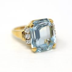 Stunning estate 14k yellow gold genuine aquamarine & diamond ring! This gorgeous statement ring features an emerald cut 16.07 carat genuine aquamarine with amazing saturation. There are three accent diamonds on each shoulder. A fabulous piece of fine modern jewelry, featuring March's birthstone! ERA - Modern, Estate METAL / MATERIAL - 14k yellow gold, genuine aquamarine (approx. 16.07 CT), 6 genuine diamonds (approx. .24 CTW, VS clarity, near colorless) MARKINGS / HISTORY - Inside of shank is st Aquamarine Brilliant Cut Diamond Ring For Formal Occasions, Formal Aquamarine Diamond Ring With Brilliant Cut, Formal Light Blue Diamond Ring, Formal Aquamarine Ring With Diamond Accents, Formal Aquamarine Diamond Ring With Gemstone, Formal Aquamarine Diamond Ring With Prong Setting, Formal Aquamarine Diamond Ring, Formal Light Blue Aquamarine Diamond Ring, Classic Aquamarine Diamond Ring