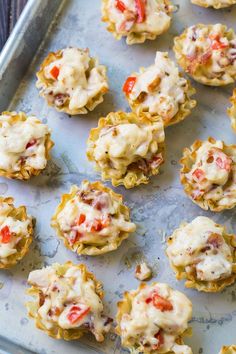 some food is sitting on a tray and ready to be baked in the oven or used as an appetizer