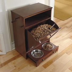 a wooden dog food stand with two bowls on it