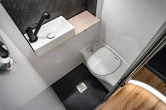 a white toilet sitting in a bathroom next to a sink