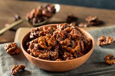 a wooden bowl filled with raisins on top of a table