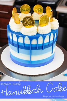 a blue and white cake with gold coins on top