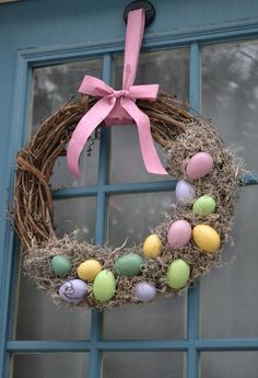 an easter wreath is hanging on the front door