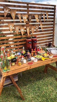 a picnic table is set up with drinks and snacks on it for guests to enjoy