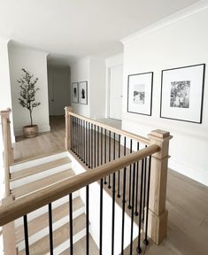 an empty room with stairs and pictures on the wall