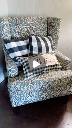 a blue and white chair with pillows on it