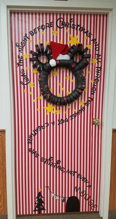 a door decorated to look like a cat with a santa hat on it's head