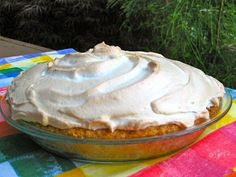 a pie sitting on top of a colorful table cloth