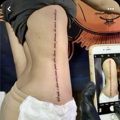 a woman with a tattoo on her lower back