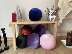 there are many different colored balls on the shelf next to each other in this room