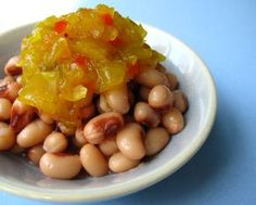 a white bowl filled with beans on top of a blue table