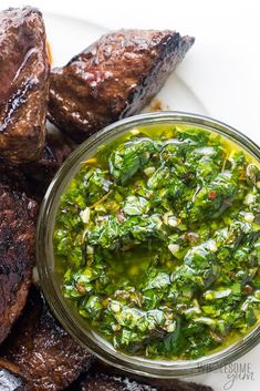 grilled steaks and green sauce on a plate