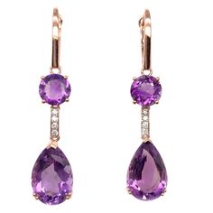 Stunning cocktail dangling amethyst earrings. High brilliance, lively purple tone, transparent clean, round faceted & pear faceted, natural 13.70 carats amethyst mounted with bead prong on high profile open basket, accented with a round brilliant diamond. Handcrafted dangling design set in 14 karats rose gold. Amethyst: 13.70 carats, high brilliance, lively purple tone, transparent clean Diamond: 0.15 carat round brilliant cut Color: G-H Clarity: SI1-SI2 Dimensions: H50mm x W10mm x D10mm (approx Luxury Purple Dangle Earrings, Luxury Amethyst Fine Jewelry Earrings, Luxury Amethyst Drop Earrings, Luxury Amethyst Dangle Earrings, Luxury Faceted Purple Earrings, Luxury Purple Fine Jewelry Earrings, Luxury Purple Faceted Earrings, Luxury Faceted Dangle Jewelry, Amethyst Jewelry Necklace